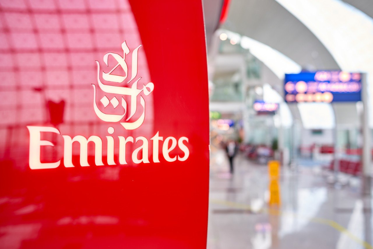 DUBAI, UAE - 31 MARCH, 2014: close us shot of Emirates logo at Dubai International Airport. Emirates is an airline based in Dubai, United Arab Emirates. 
